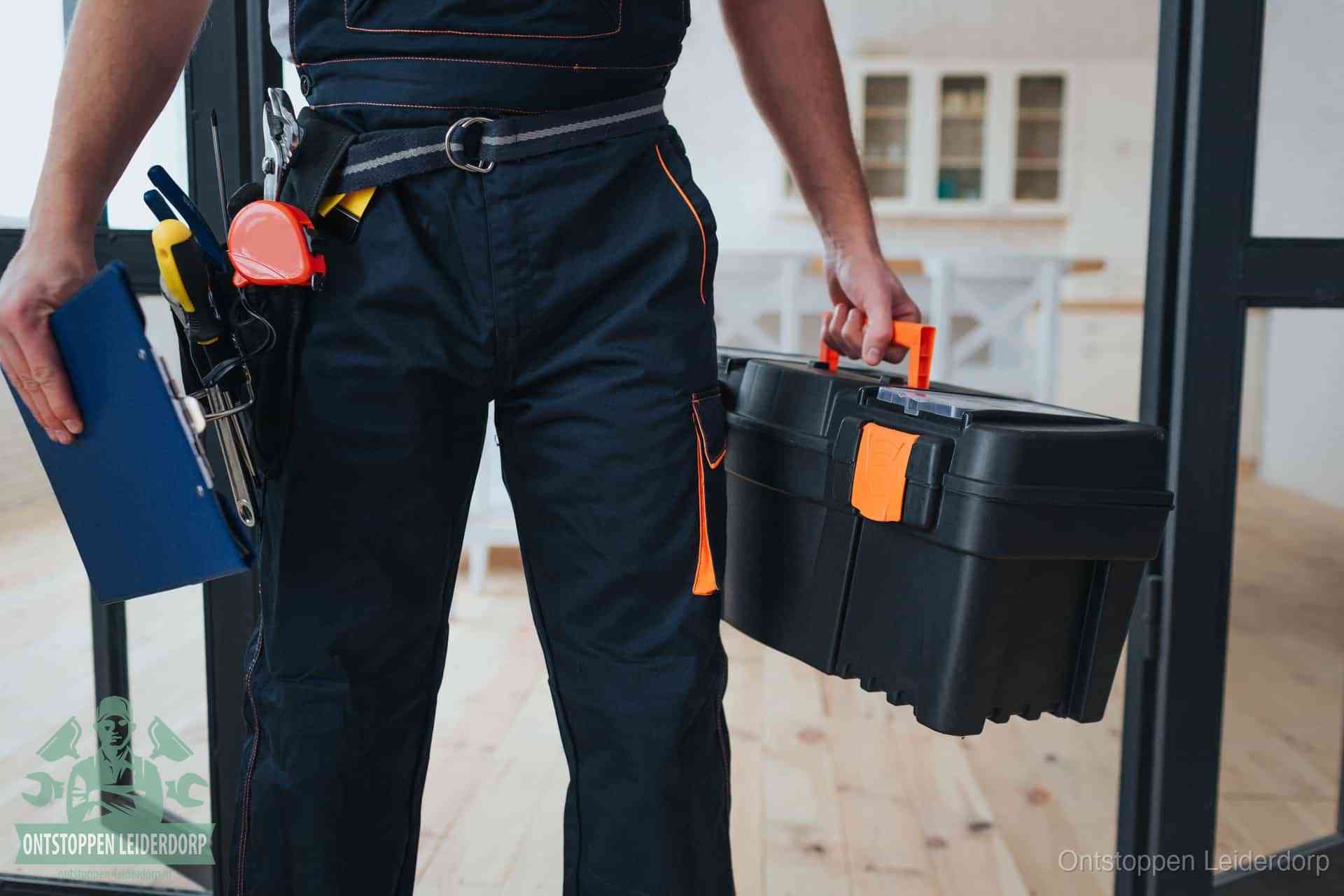 Een monteur met gereedschapsriem en klembord, klaar om een transparante prijs voor het wc ontstoppen in Leiderdorp te geven