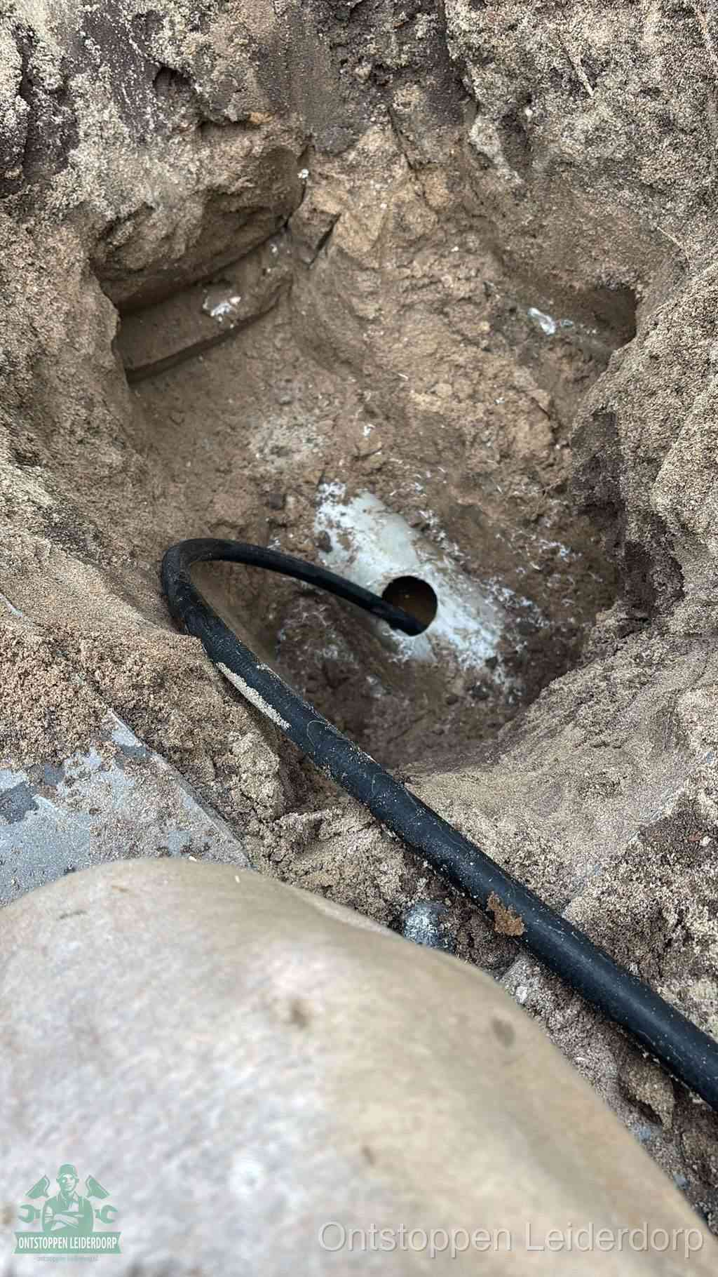 Uitgegraven rioolbuis in de grond, hulp om zelf het riool te ontstoppen in Leiderdorp